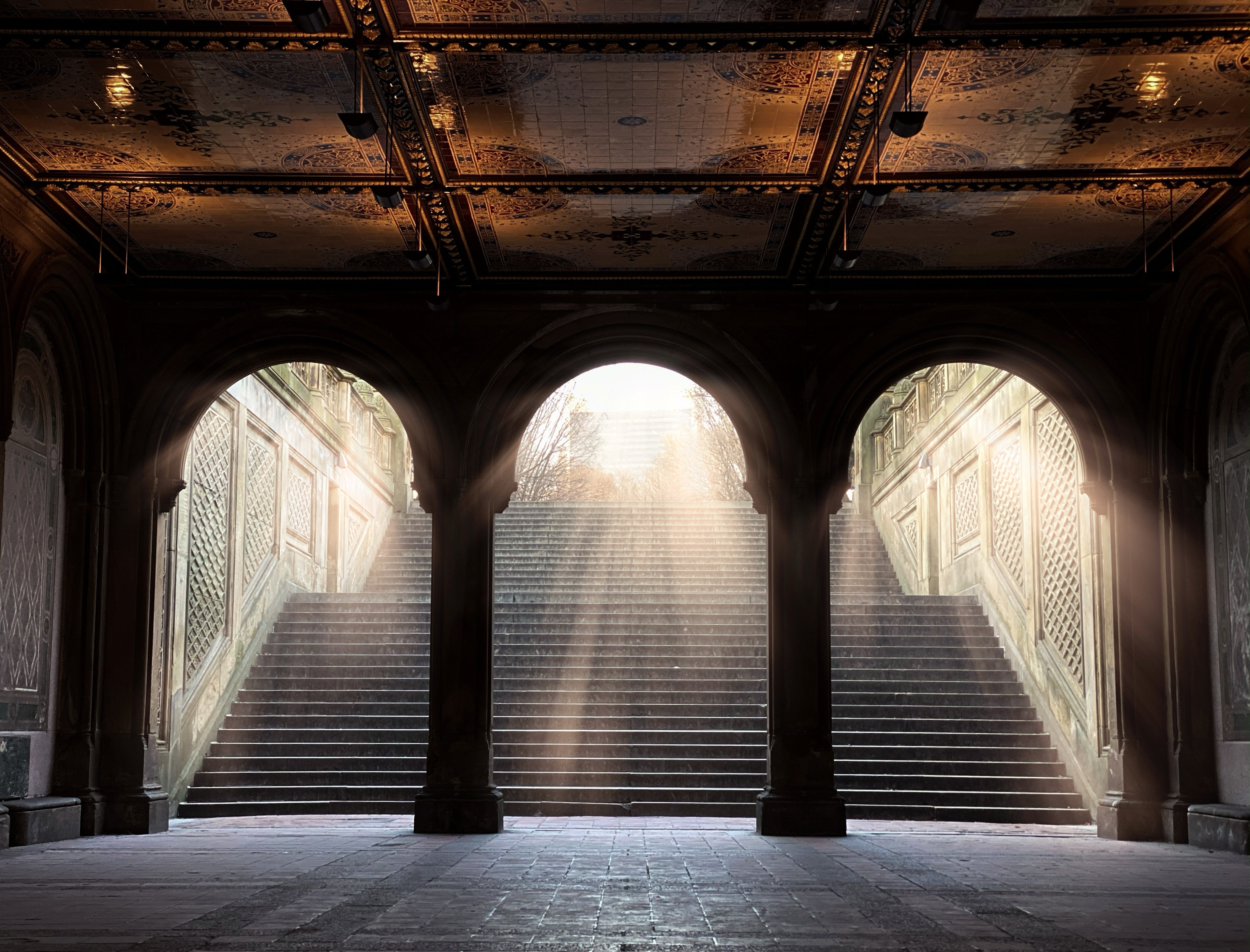 Ornate archway with grand staircase beyond