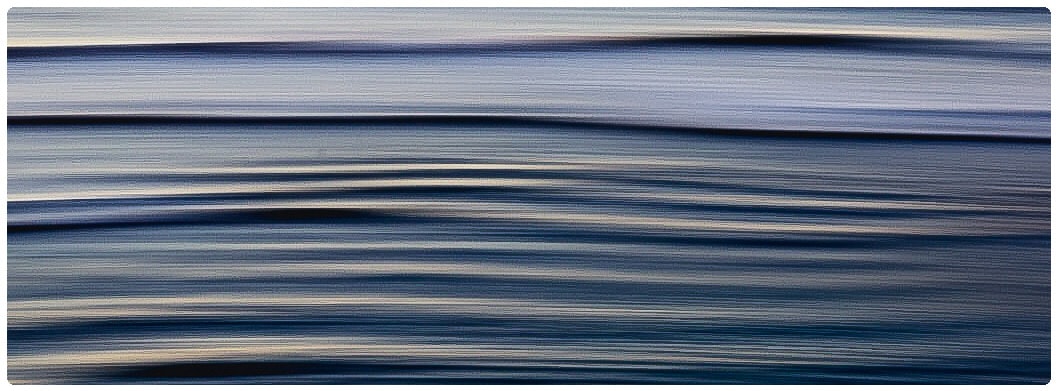 Abstract motion blur seascape with layered horizontal bands of deep blue and soft silver-white